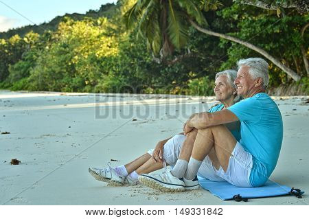 Happy elderly couple rest at tropical beac