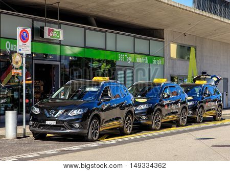 Wallisellen, Switzerland - 7 July, 2016: taxi cars with UBS Paymit application promotion. UBS Paymit application allows to send request and receive money using a smartphone.