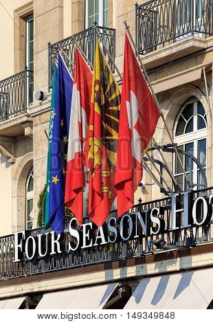 Geneva, Switzerland - 24 September, 2016: flags over the entrance to the Four Seasons Hotel Les Bergues. Hotel Les Bergues has been a landmark on Lake Geneva since 1834.