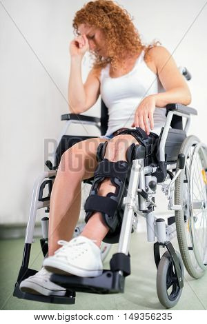 Dejected Woman With Her Knee In A Brace
