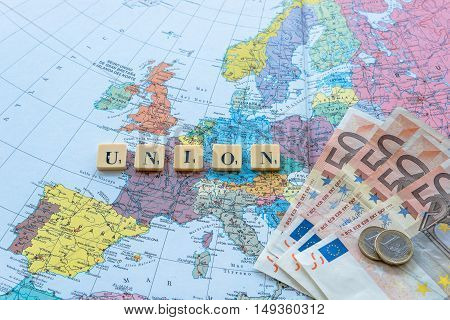 London UK - June 12 2016: Union word with euro money on european map. The United Kingdom European Union membership referendum on 23 June 2016