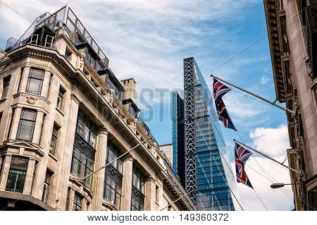LONDON UK - AUGUST 21 2015: Street in the city of London with the contrast between historical buildings and new skyscrapers
