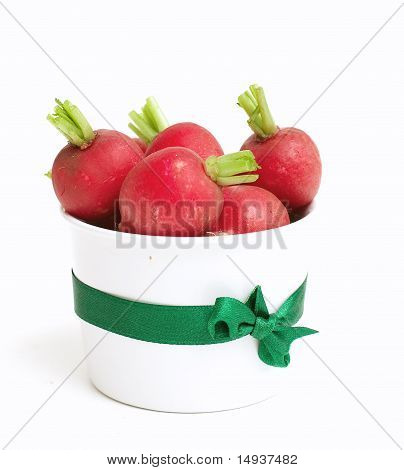 fresh radish in a glass tied with a ribbon