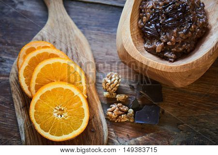 Delicious rice porridge with chocolate and nuts in a wooden bowl