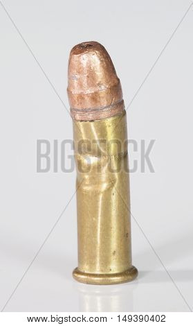 Rimfire cartridge that has been ruined on a white background