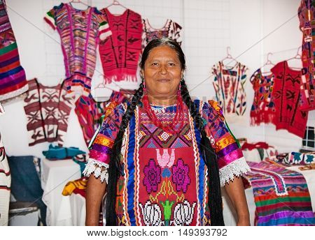 OAXACA MEXICO- DECEMBER 7, 2015: Mexican women selling handicrafts and carpets in Oaxaca on December 7, 2015, Mexico.