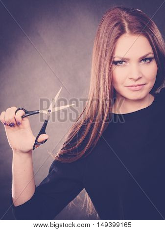 Elegance and classy. Fashion style of hairdo. Female professionalist with scissors. Elegant woman presents her hairdresser's saloon.