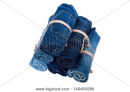 the jeans twisted in rolls on a white background