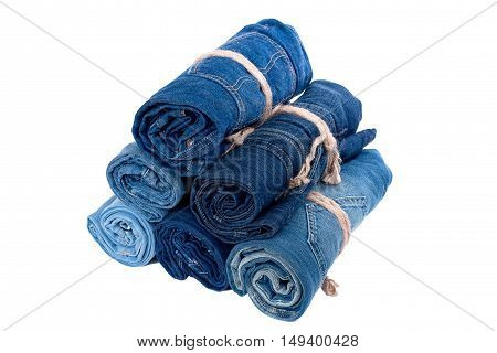 the jeans twisted in rolls on a white background