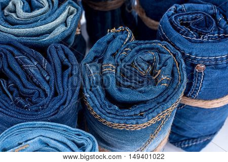 the jeans twisted in rolls on a white background