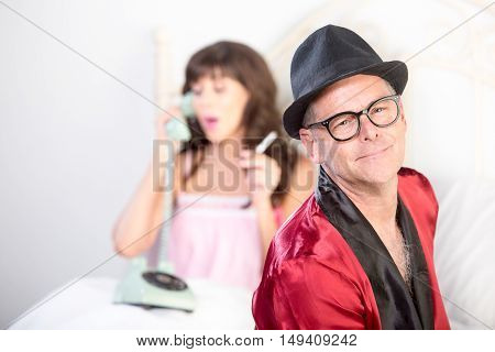 Playboy With Woman On The Phone And Smoking In Background