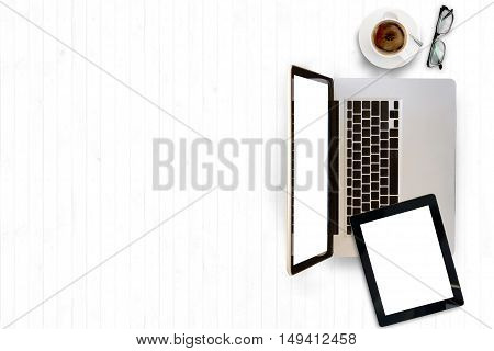Top view of white office desk with laptopcup of coffee and supplies. Top view with copy space.