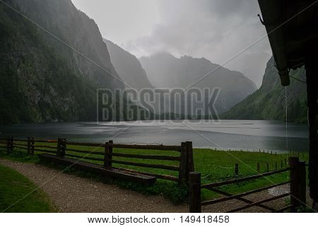 Farm house and boat dock hangar on Obersee mountain lake in Alps. Bavaria Germany