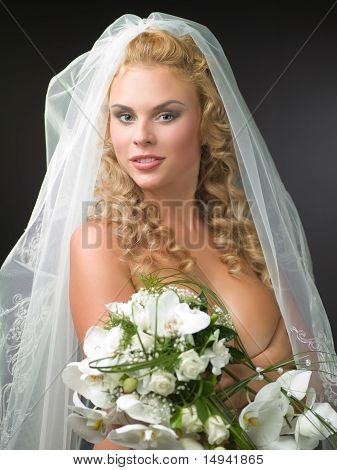 Woman In A Veil Bride With A Bouquet Of Flowers