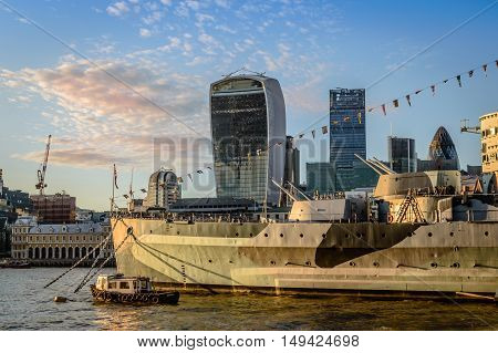 LONDON UK - AUGUST 21 2015: London cityscape at sunset. View from City Hall with warship on the foregound