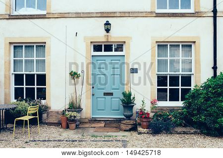 Cirencester UK - August 18 2015: English town house entrance with front courtyard and a painted closed door