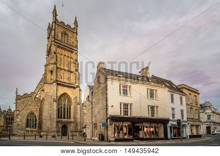 CIRENCESTER UK - AUGUST 11 2015: The Church of St. John the Baptist in Cirencester at dusk. Cirencester is a market town in the Cotswolds.