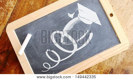 American football and academic cap. Chalk on Blackboard.