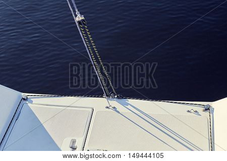 permanent backstay is attached to the top of the mast. water background