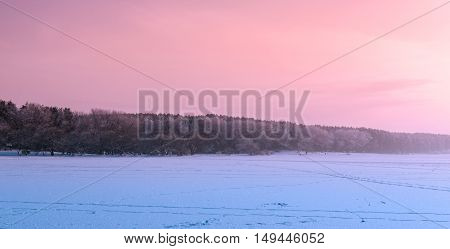 Twilight on the frozen lake in winter time