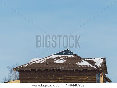 Wood house in village with roof in snow in winter time