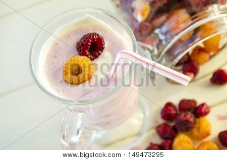 milkshake with berries fresh raspberries on a white background