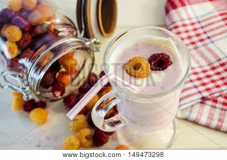 milkshake with berries fresh raspberries on a white background