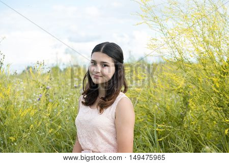 Girl in guipure dress resting on the meadow