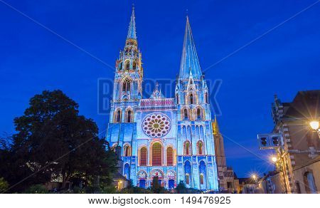 The Our Lady of Chartres cathedral illuminated during Chartres Light show. Colorful light illumine historic places and some principal buildings throughout the event.