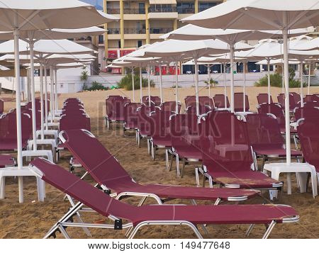 empty beach city Rethymnon Crete sand sun loungers