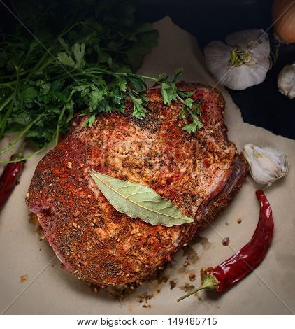 raw piece of pork, onion, pepper, garlic, parsley