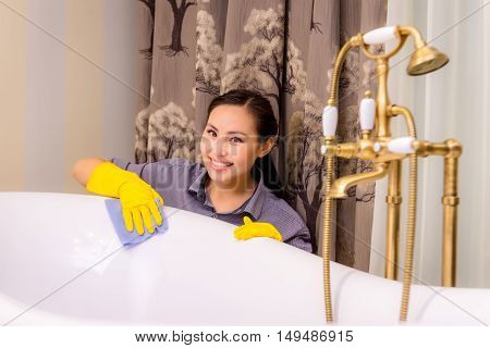 Young beautiful asian woman housekeeping in the bathroom