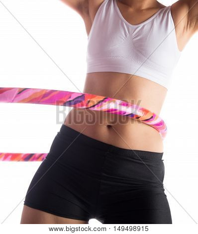 Woman working out with hoola hoop daily excercise at home