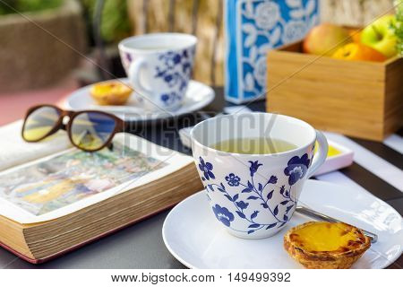 Relaxing afternoon tea and biscuits outside with natural light