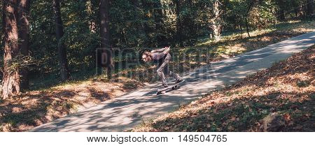 Skateboarder Ride A Longboard Through The Forest – Panorama