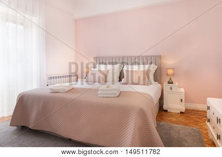 Beautiful and bright bedroom with pink sheets