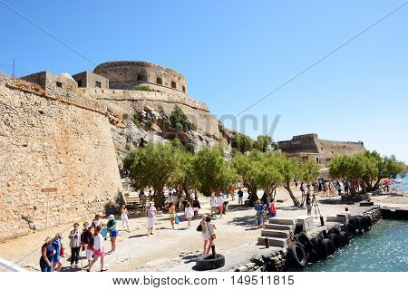 SPINALONGA GREECE - MAY 14: The tourists are on Spinalonga island on May 14 2014 in Spinalonga Greece. Up to 16 mln tourists is expected to visit Greece in year 2014.