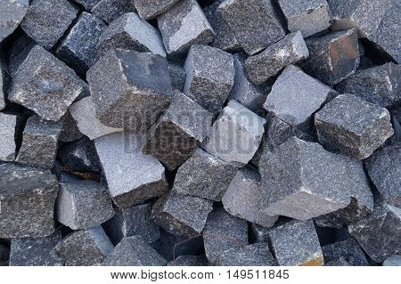 Pile of grey cube granite stones, texture
