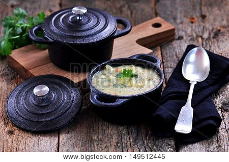 Thick soup of corn grits with potatoes, carrots, garlic, dill and coriander