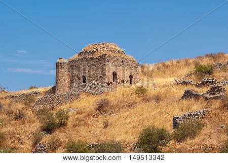 Ruins of an ancient temple fortress upper Corinth the inner part is surrounded by old walls on a bright Sunny day. The Peloponnese Greece.