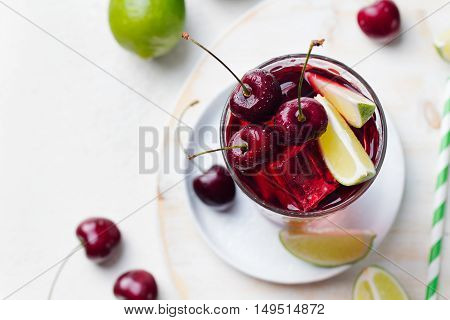 Cherry Limeade, lemonade, cola, cocktail in a tall glass on a white background Top view Copy space