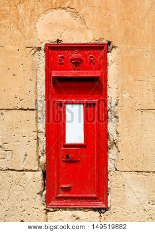 traditional red English letterbox mounted in a dry stone wall 2013.
