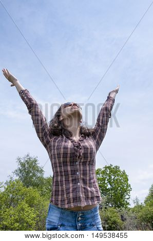 Girl in a shirt lifted her hands up