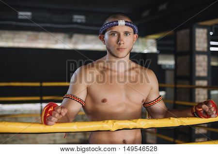 Man Fighter Muay Thai Stand in the ring
