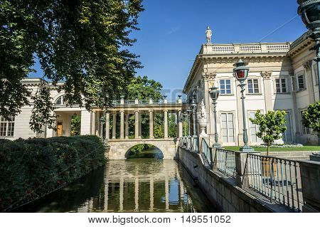 WARSAW POLAND - SEPTEMBER 27: Little bridge with columned gallery on the Lazienki canal near the Lazienki Palace the Palace on the Water in Royal Baths Park Lazienki Park in Warsaw Poland on September 27 2016