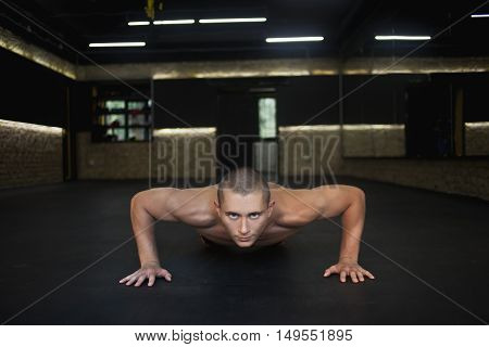 a man pushed from the floor in the gym. Concept workout healthy lifestyle sport