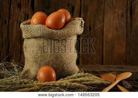 Fresh eggs on wooden background from farm and prepare for cook in kitchen room, Organic food and clean food for healthy, Eggs from farm to the market for raw material to cooking by chef in restaurant.