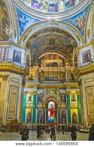 SAINT PETERSBURG RUSSIA - APRIL 25 2015: The splendid iconostasis of St Isaac's Cathedral with precious malachite and lazurite columns gilt sculptures carved patterns and stained-glass window on April 25 in Saint Petersburg.