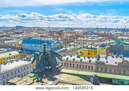The Colonnade of St Isaac's Cathedral overlooks the roofs of historic city St Petersburg Russia.