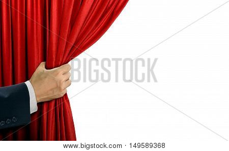 Hand opening stage red curtain over white